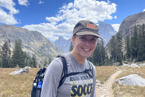 Liz Haley '23 in Grand Teton National Park on a trail with mountains behind her