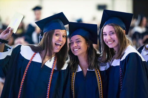 three grads in gowns