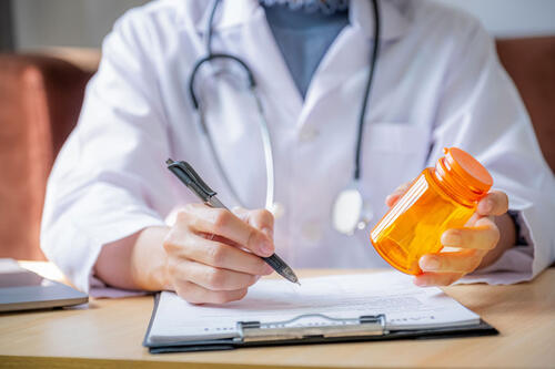 pharmacist with pill bottle