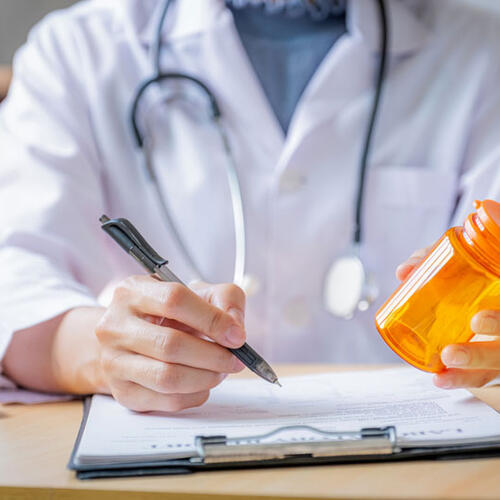 pharmacist with pill bottle