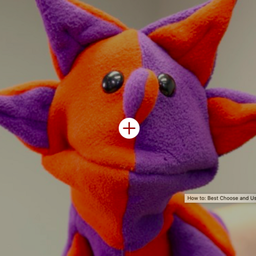 purple and orange hand puppet with spikes on his head